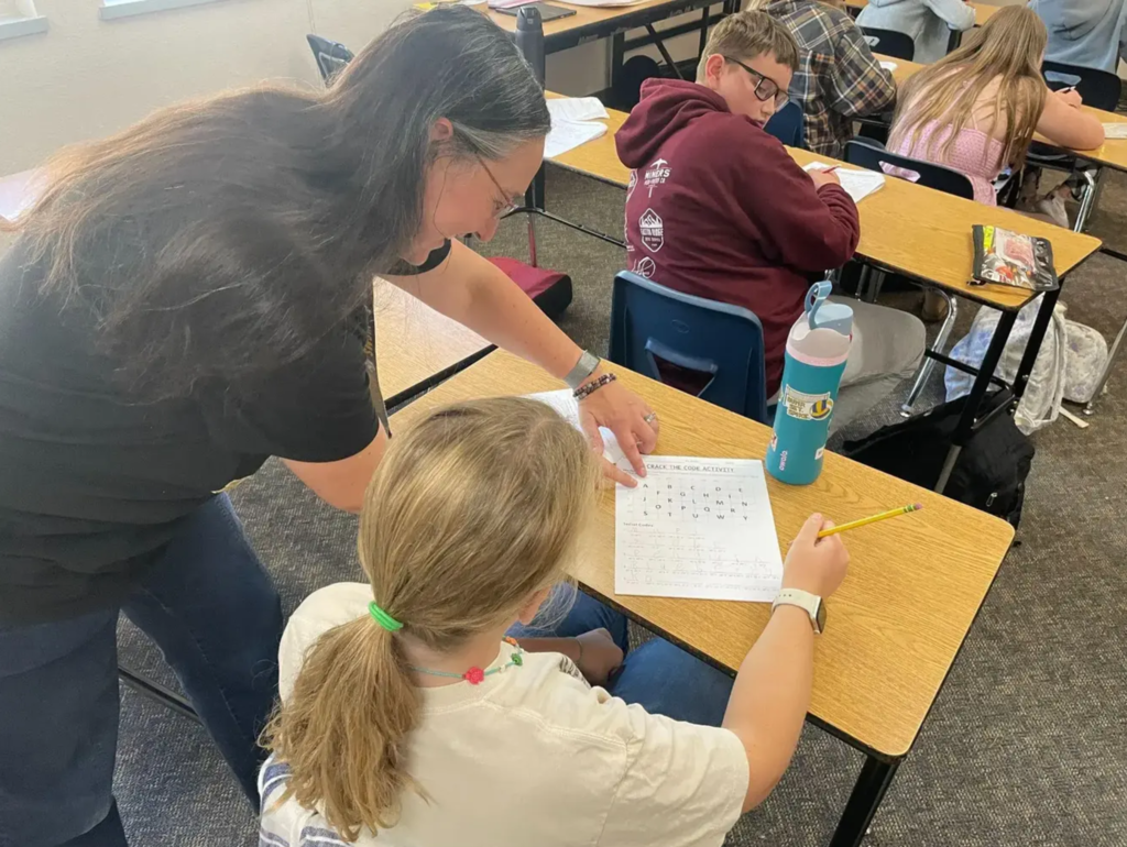 Mrs. Browitt helping a student working on an assignment