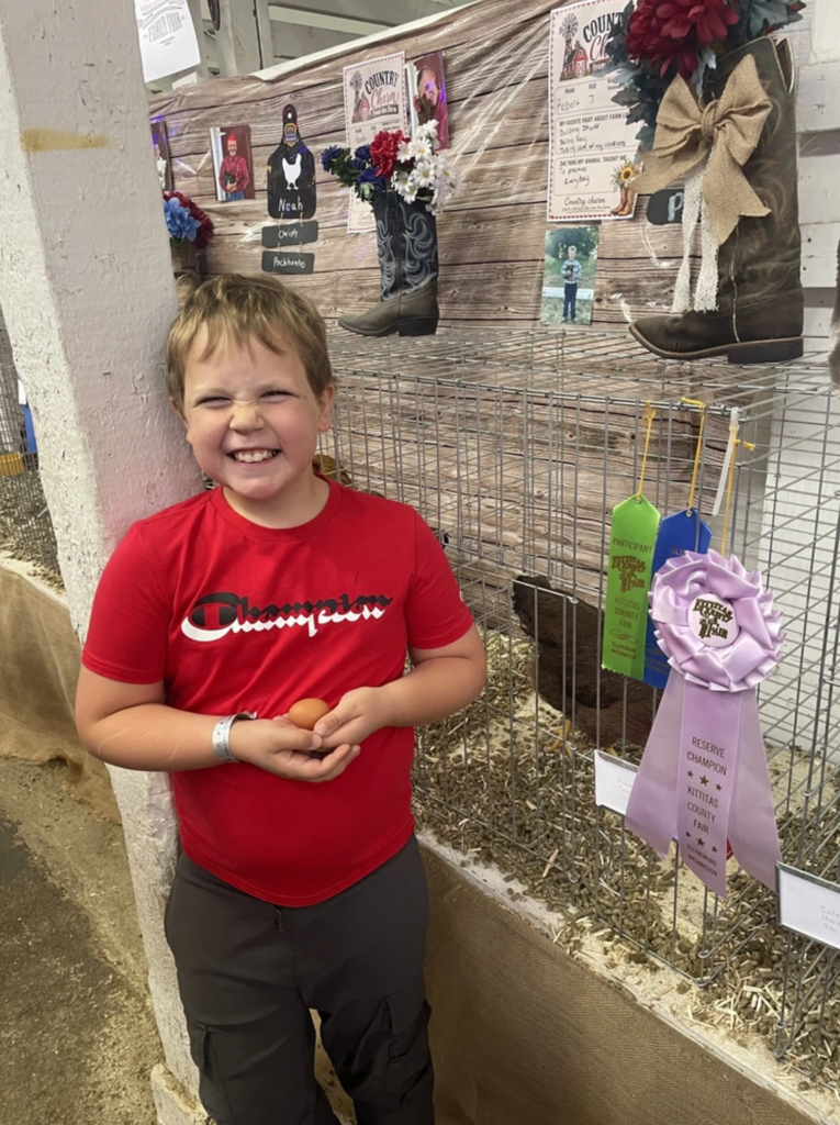 student with his ribbons at the county fair