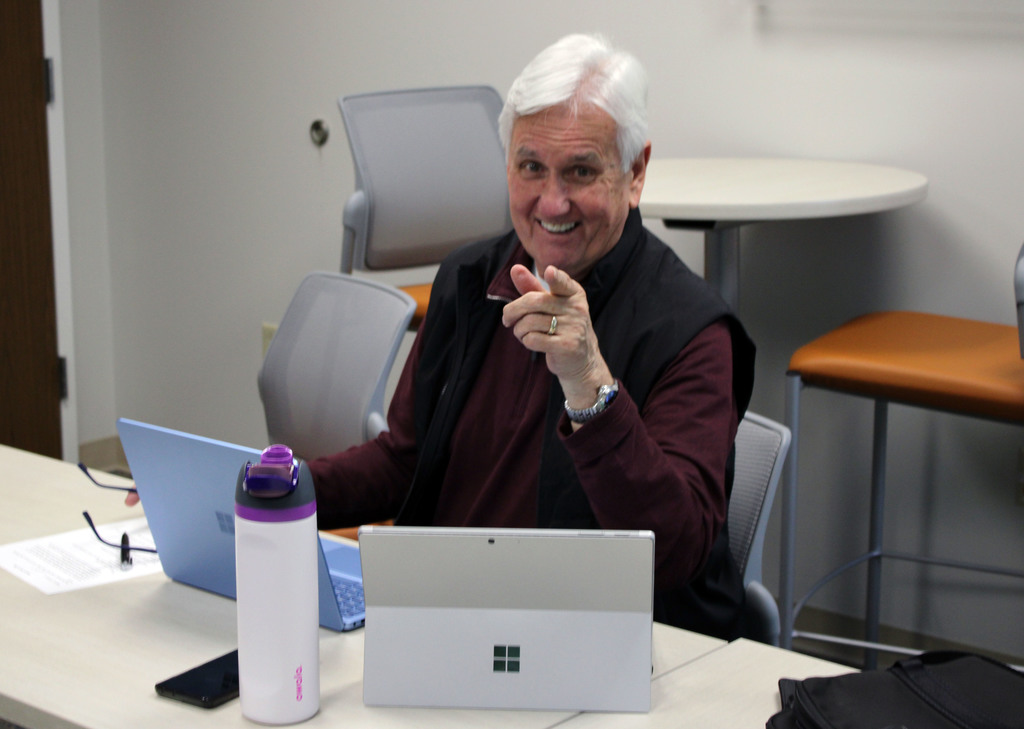 Bob Pautke points at the camera with a smile. 