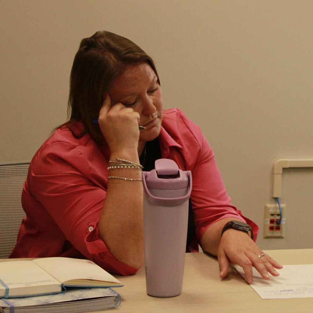Woman focusing during the Student Success Team meeting.