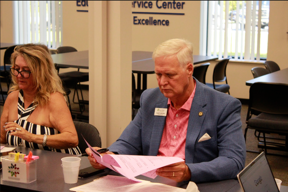 Great Oaks Career Campuses President/CEO Harry Snyder reviews paperwork at the 8/27/26 Superintendents meeting.