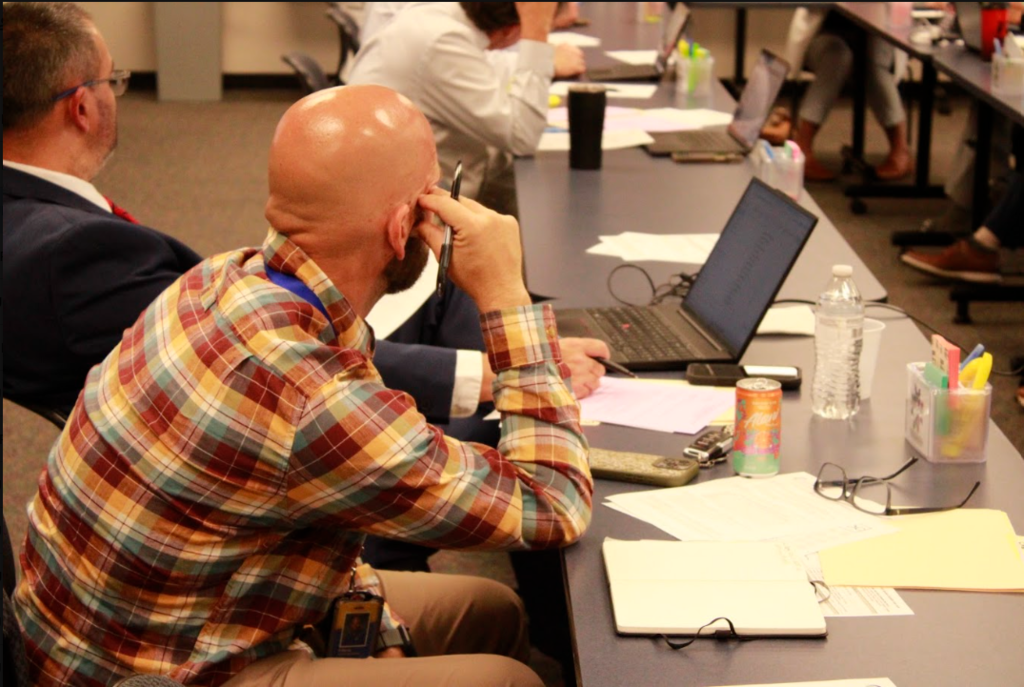 Clermont Northeastern Local Schools Superintendent TJ Dorsey looks over towards Goshen Local Schools Superintendent Brian Bailey during the 8/27/26 Superintendents meeting.