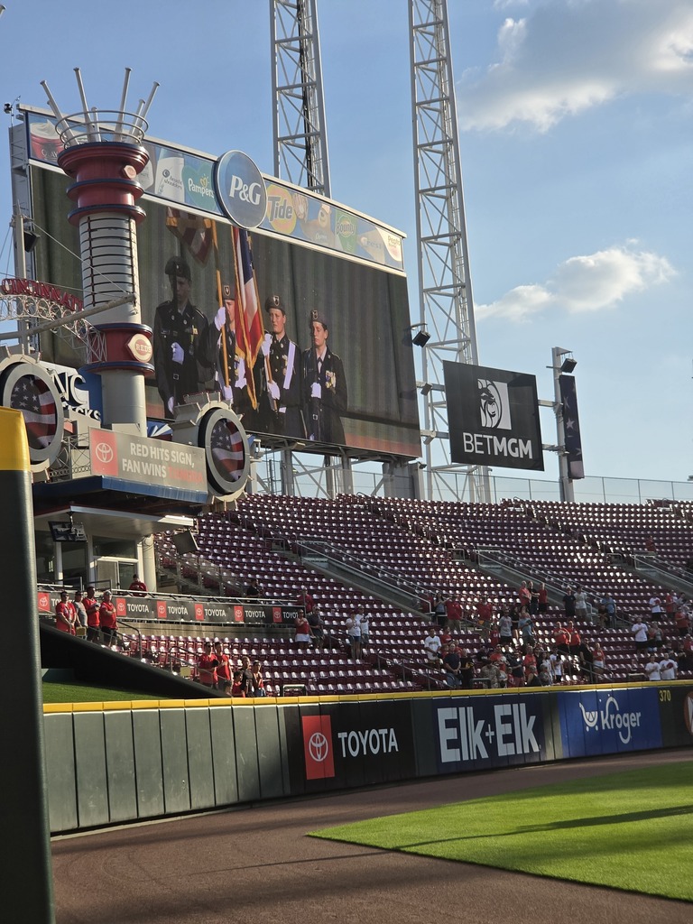 CNE JROTC Color Guard's picture on the Cincinattis Red's jumbo tron presenting the ntional and state flag.