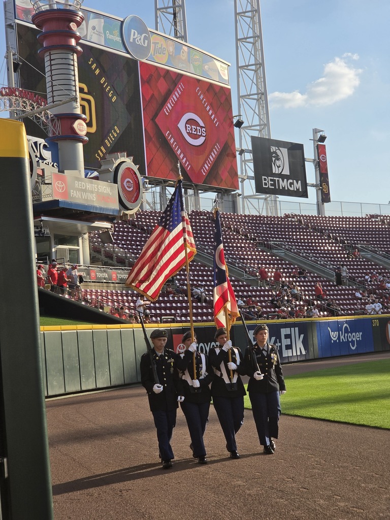 CNE Color Guard marching with the Cincinnati Red's Jumbo Tron in the back ground