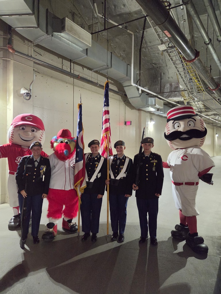 JROTC Cadet in there dress uniforms posing with the Cincinnati Red's Mascots