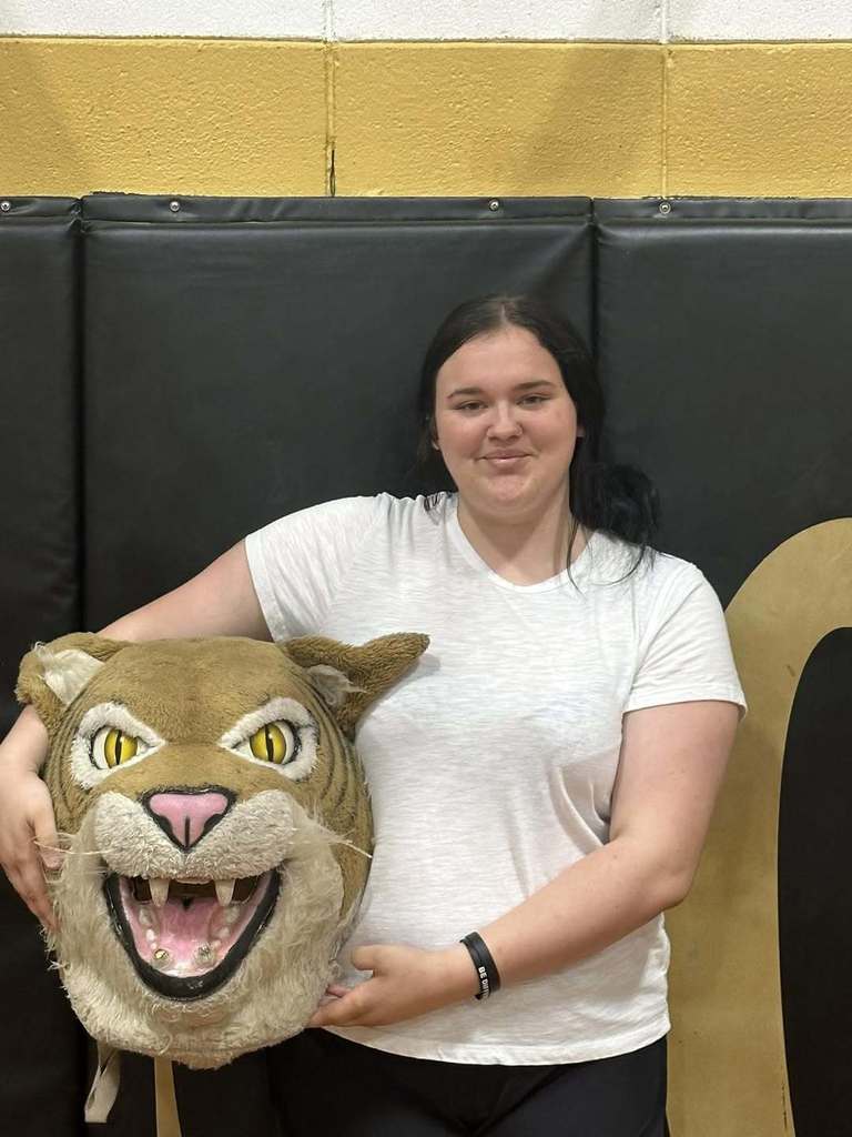 girl holding mascot head
