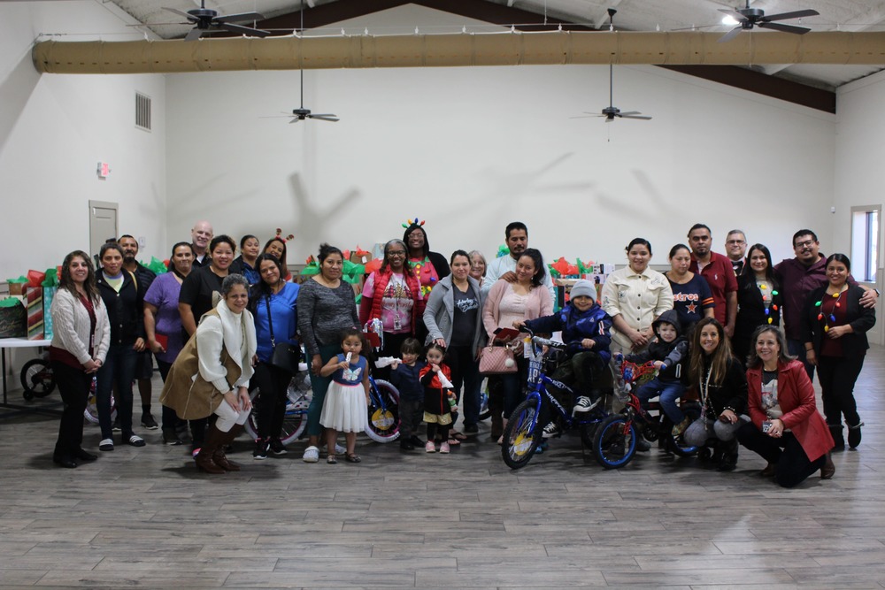 A group photo of all families that received gifts from CHP  management