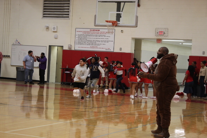 Orange, Black, Red color flyer with District Logo;  along with sports teams  and  organizations  Photos!