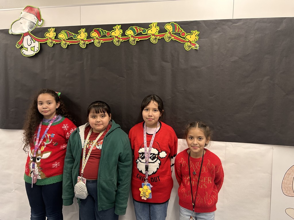 Children wearing Christmas ugly sweaters