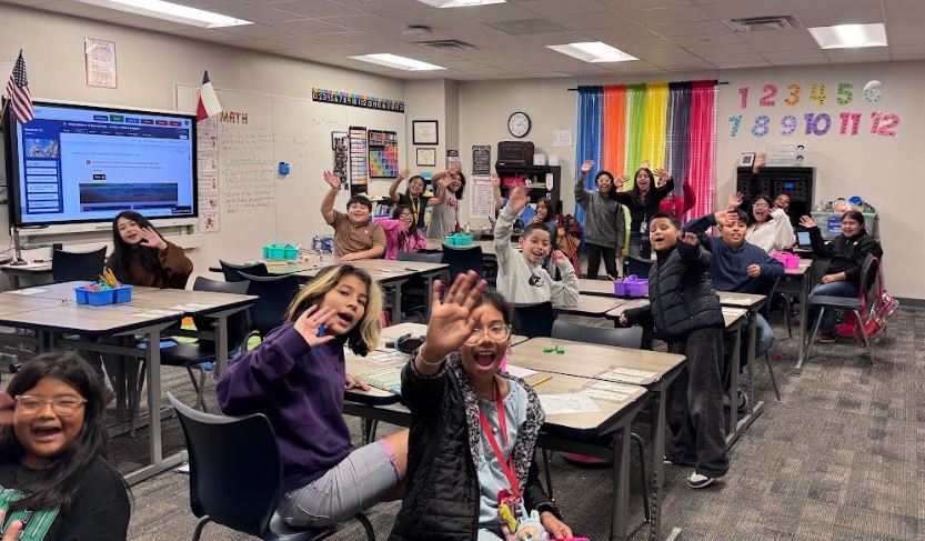 Students waving at the camera