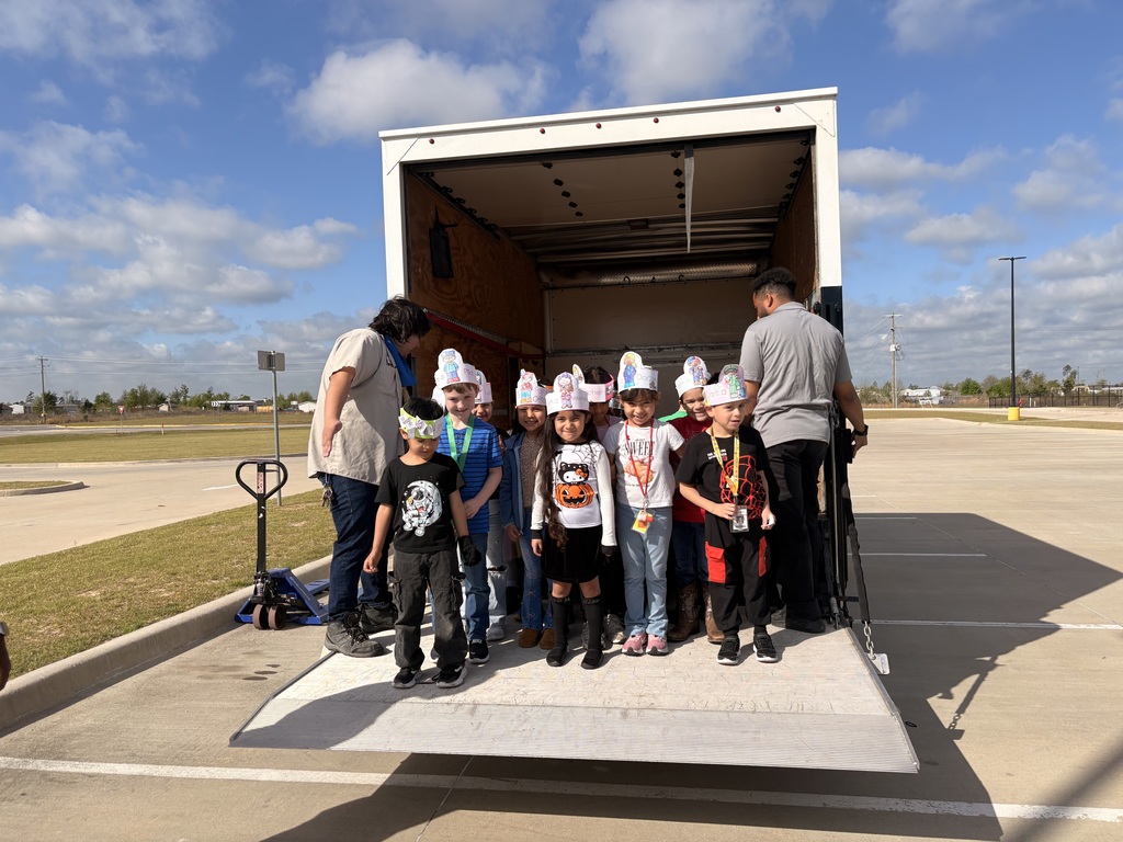 Students standing inside a truck