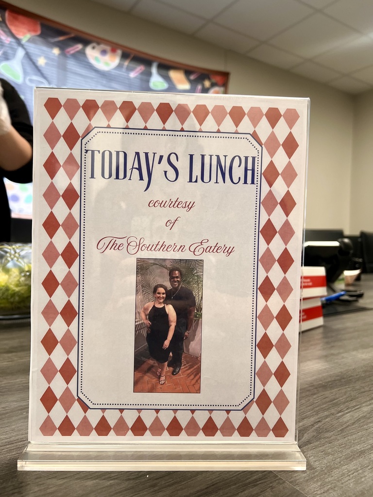 A white and red menu card with "Today's Lunch" text on it. A photo of a man and a woman is displayed.