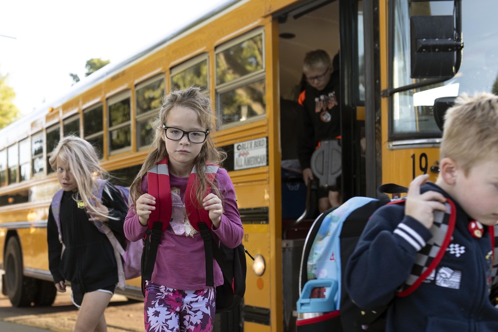 Student by school bus