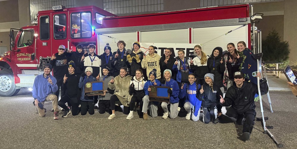 Runners in front of a fire truck
