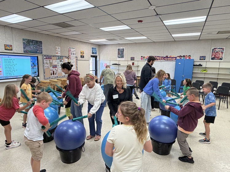 SCES parents and students playing the drums