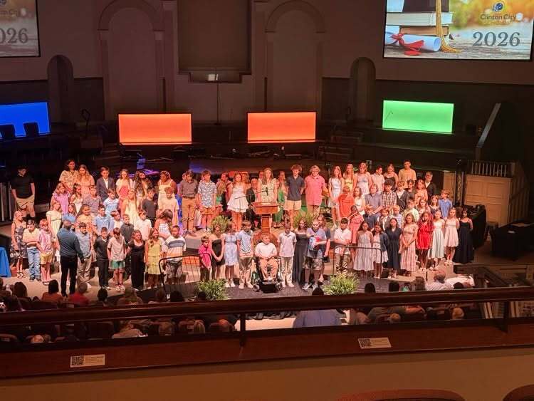 6th grade graduation picture showing ferns that were donated by Willow Ridge Garden Center