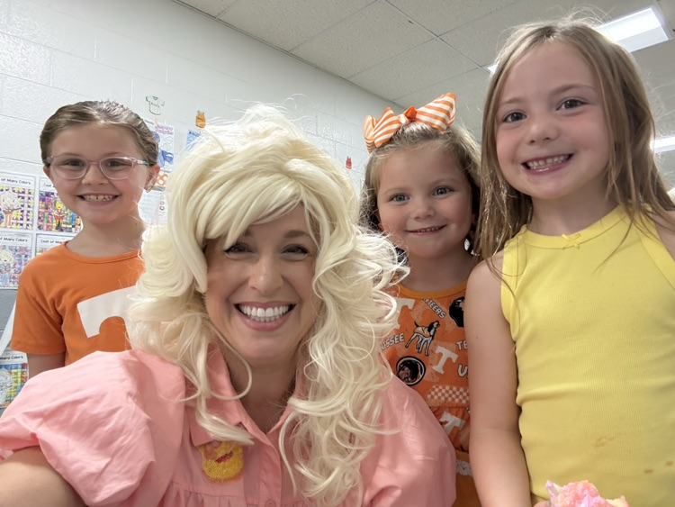 Mrs. McAmis dressed as Dolly Parton with 3 students