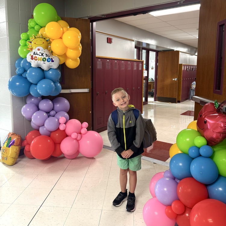 student smiling with balloons