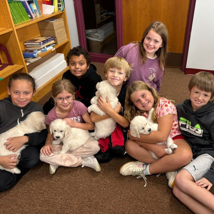 students holding puppies visiting bluff 