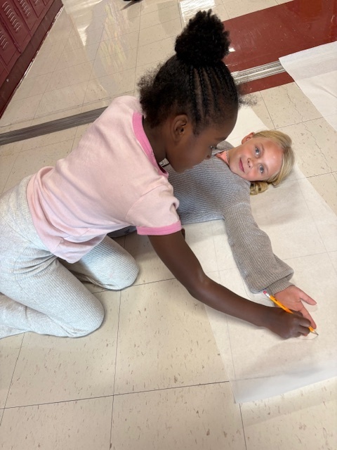 measuring wing span of student