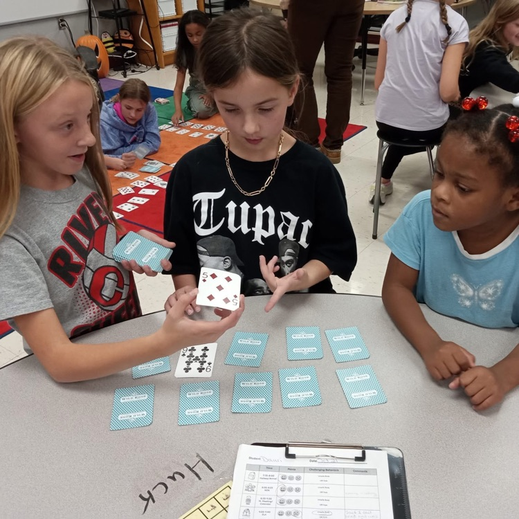 big students teaching littles how to play garbage 