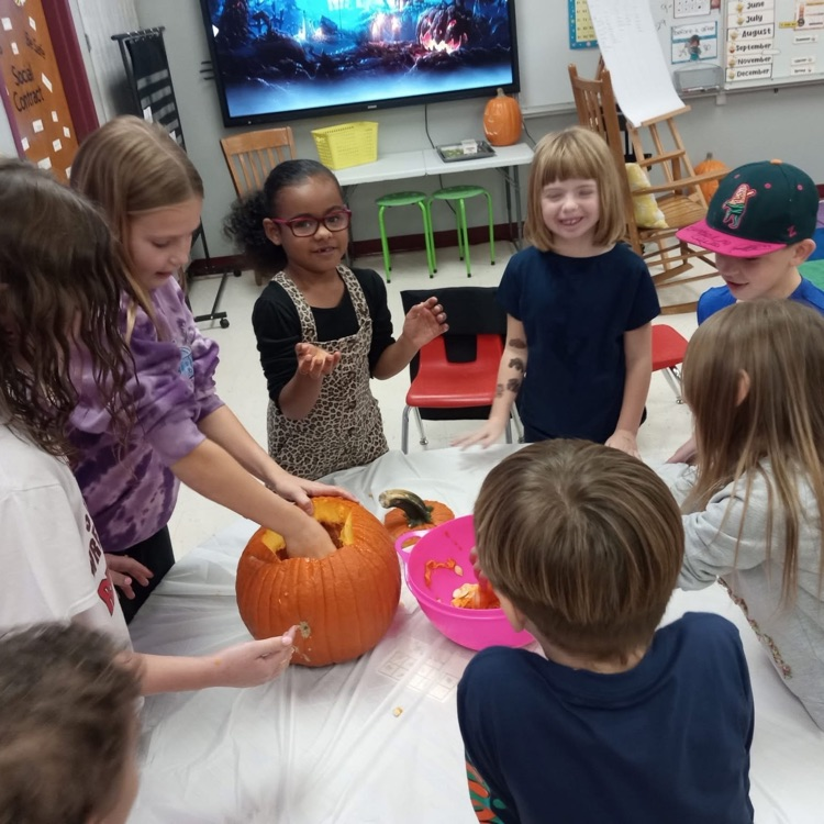 students inspect pumpkin