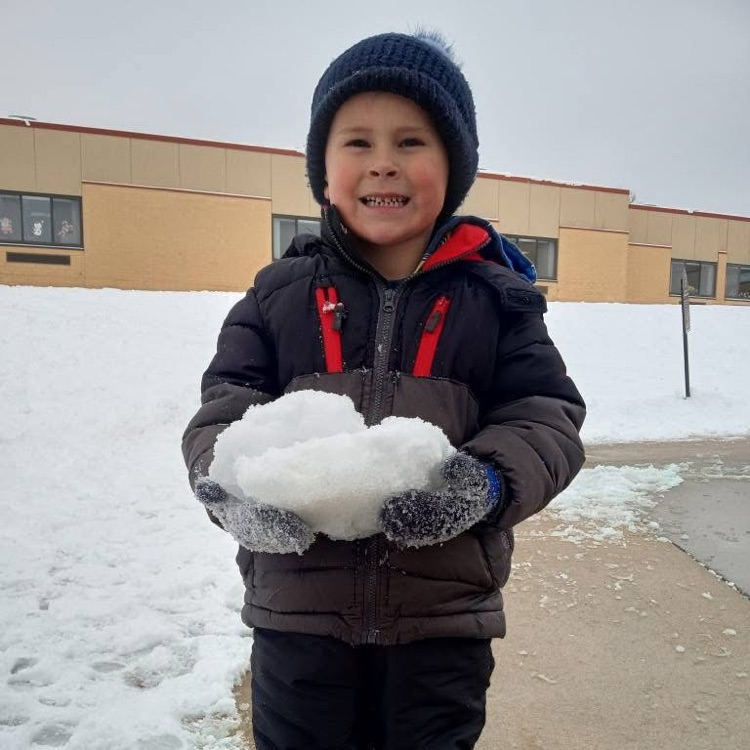 boy holds clump of snow