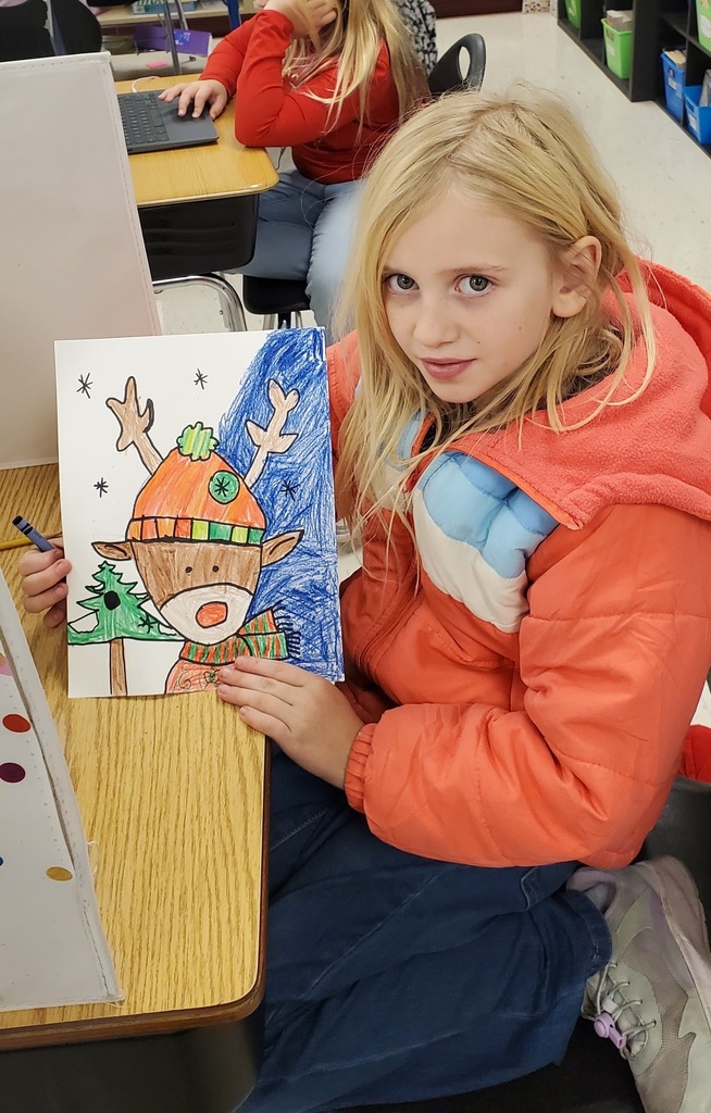 student showing reindeer art
