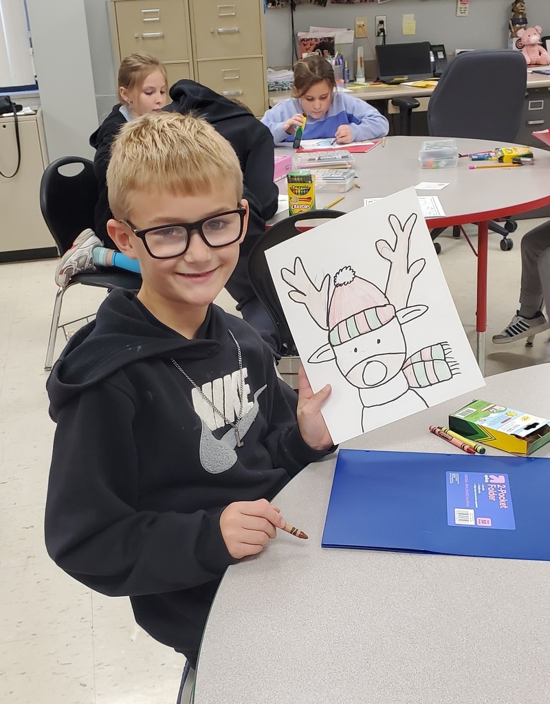 student showing reindeer art