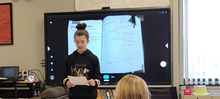 student speaking to class about invention