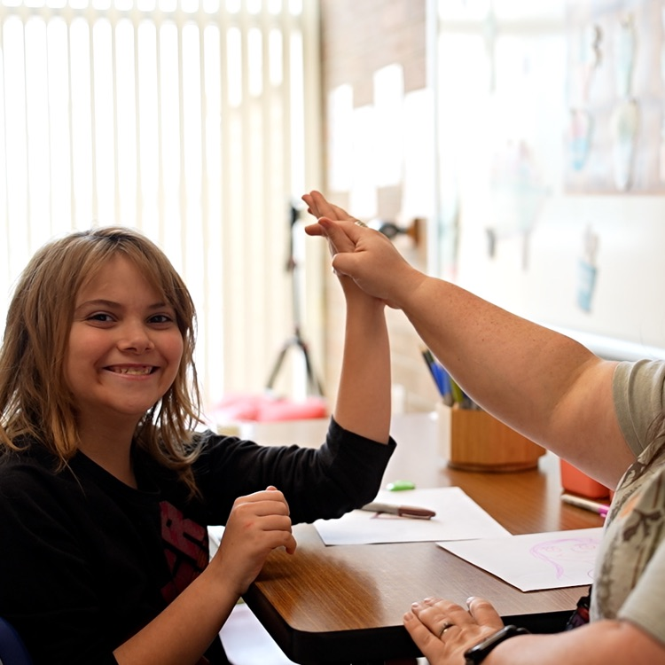 social worker high fives student