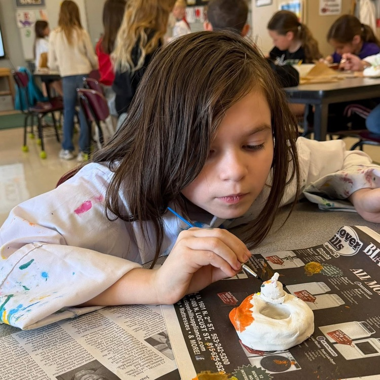student painting clay art