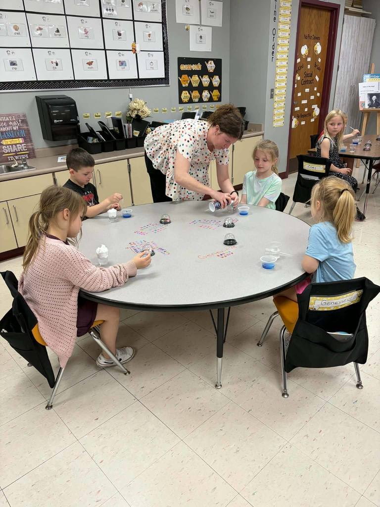 mrs fergurson helping students with project