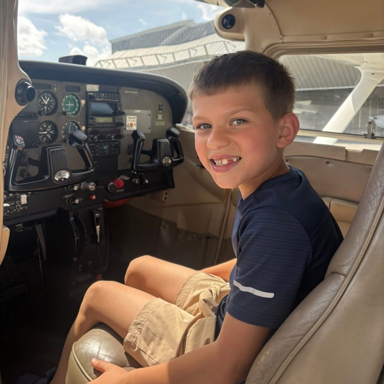 student sits in airplane