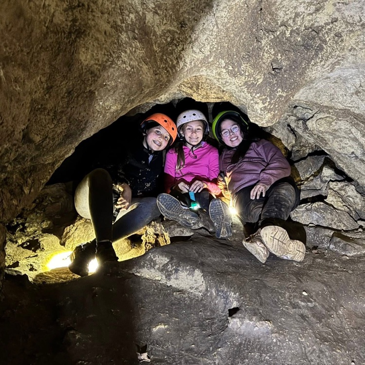 students sitting in cave