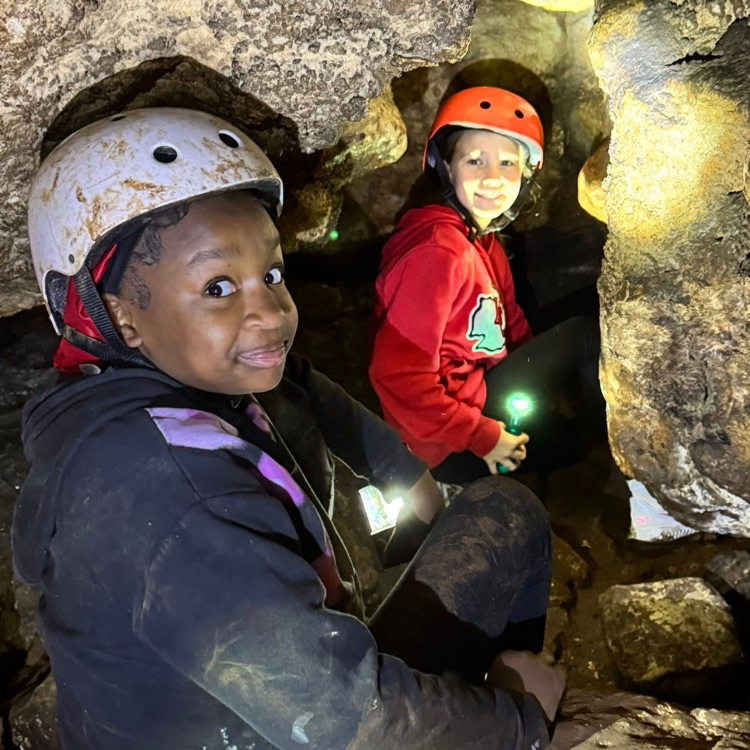 students walking through cave