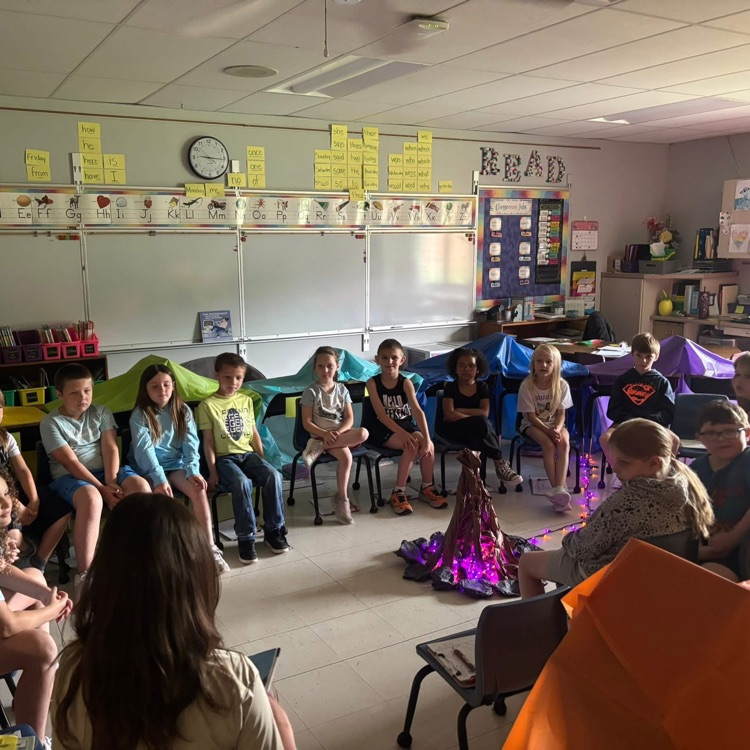 students sitting around fire