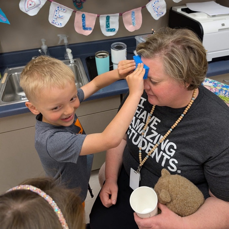 student putting tattoo on staff