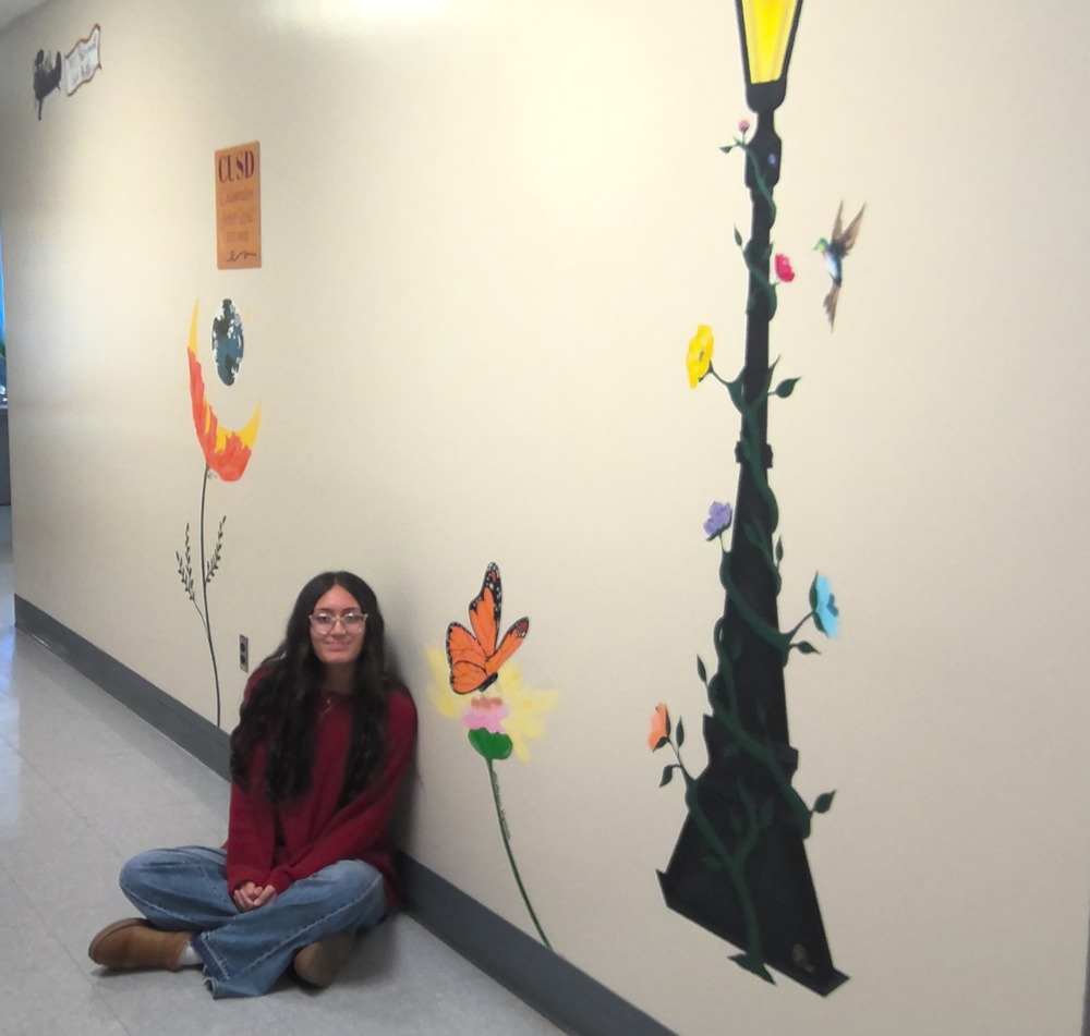 L Visinia Adds to Artist Wall