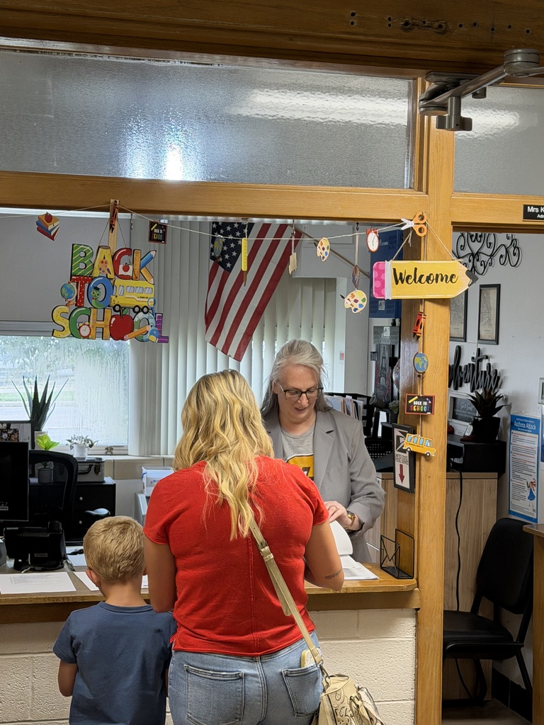 Mrs. Shaw helping a parent find information