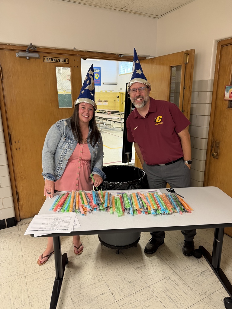 Mr. Creighton and Mrs. Lange handing out popsicles in a magical way.  