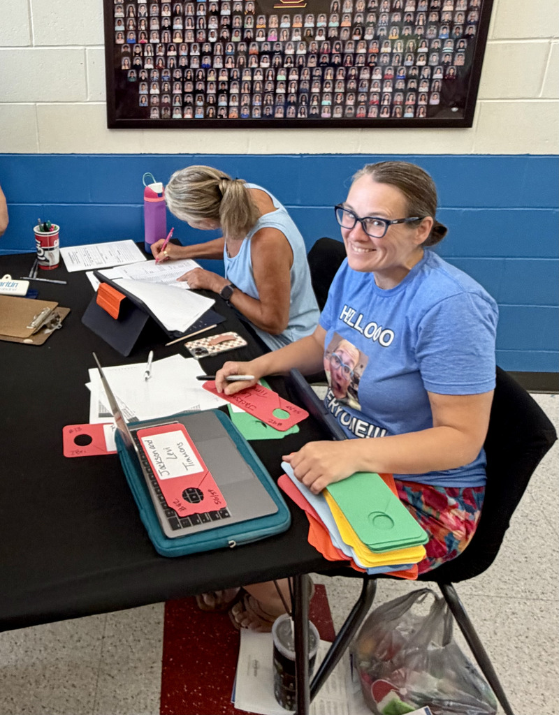 Mrs. S helping with Bus information with Mrs. Pruser