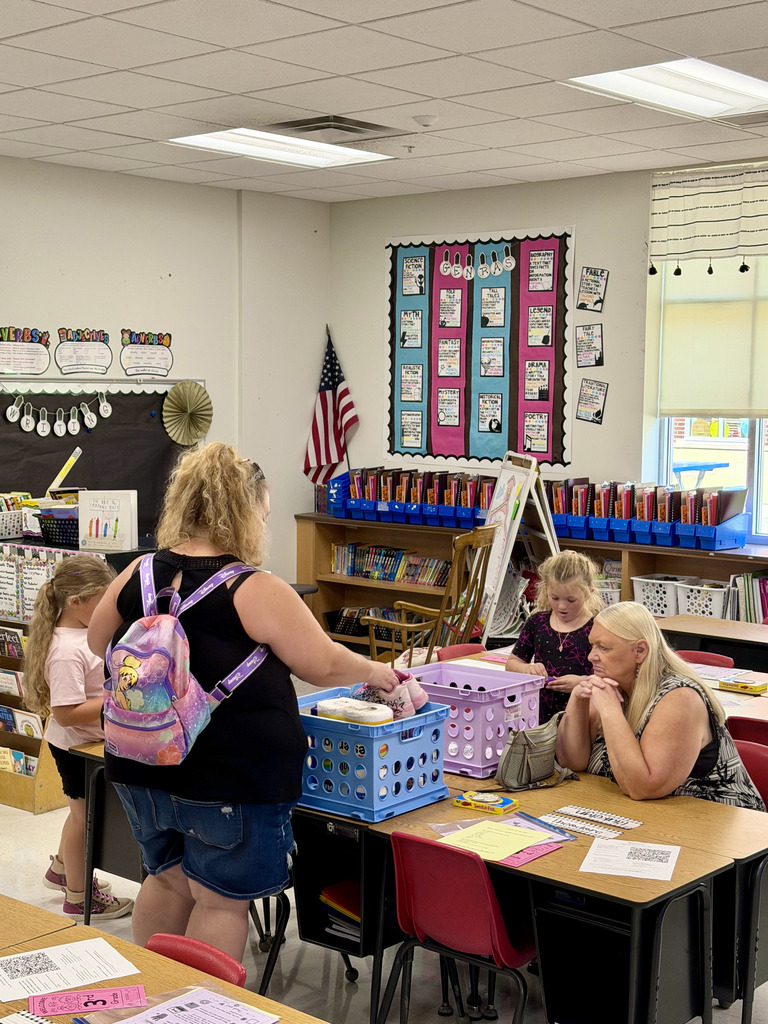Parents and students unpacking school supplies