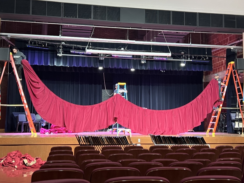 CMS auditorium new curtain being hung