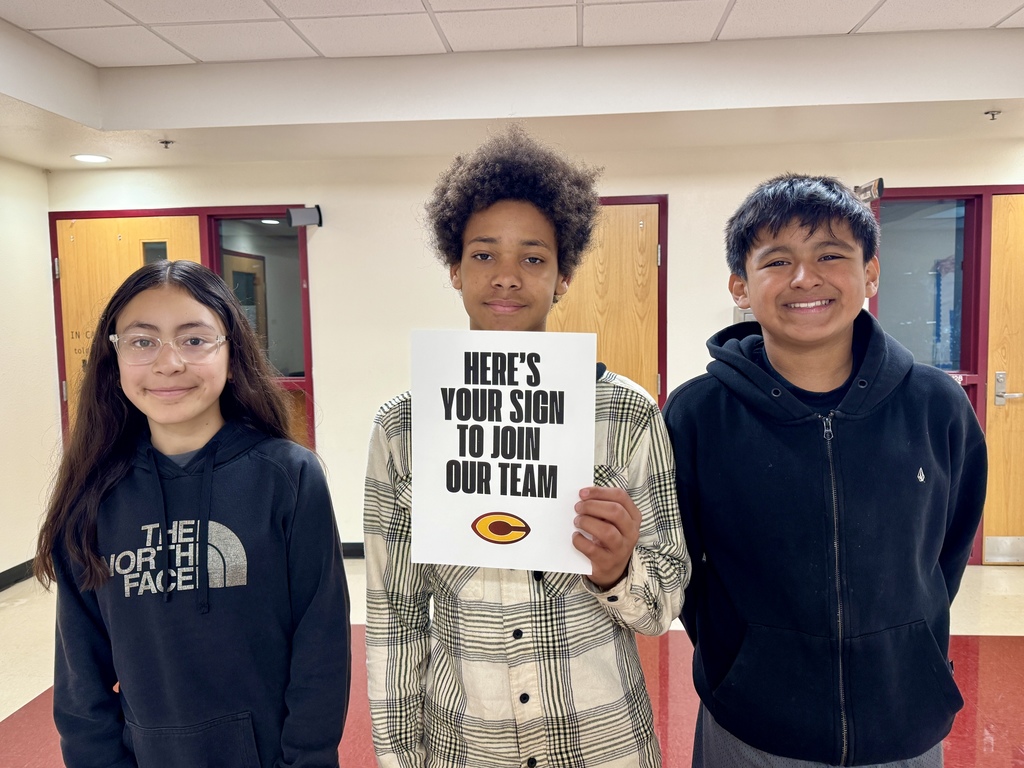 3 students holding a sign to join our team