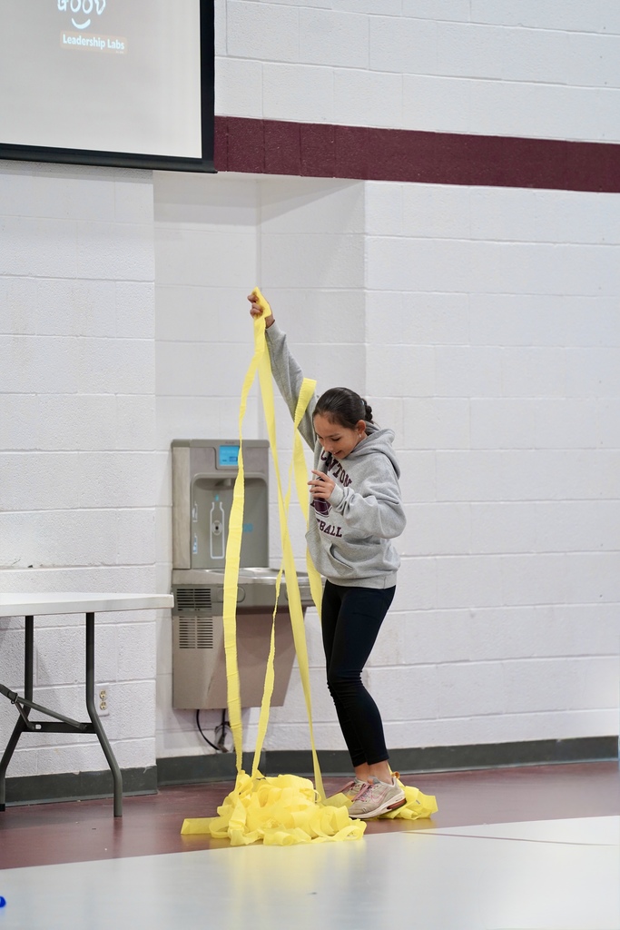 Student unrolling yellow tissue paper