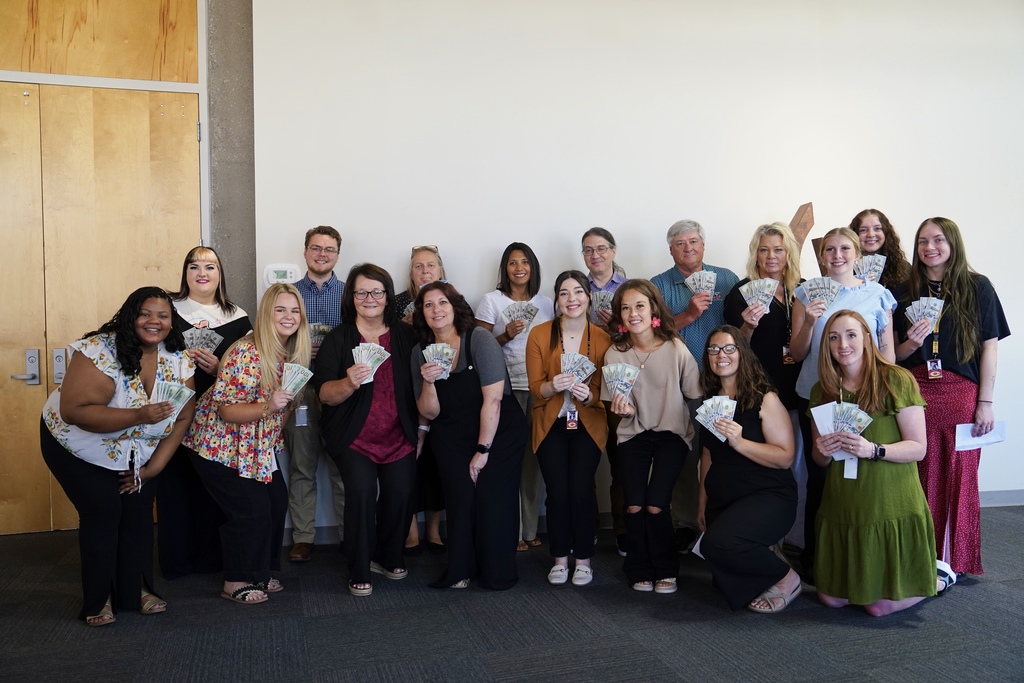 CPS new teachers holding cash from the Clinton Public School Foundation
