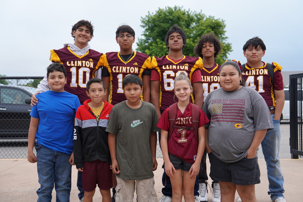 Members of the CHS Football Team greeting students at SW.