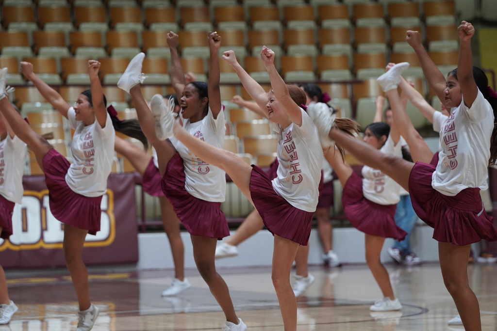 Cheerleaders doing a cheer at the pep assembly