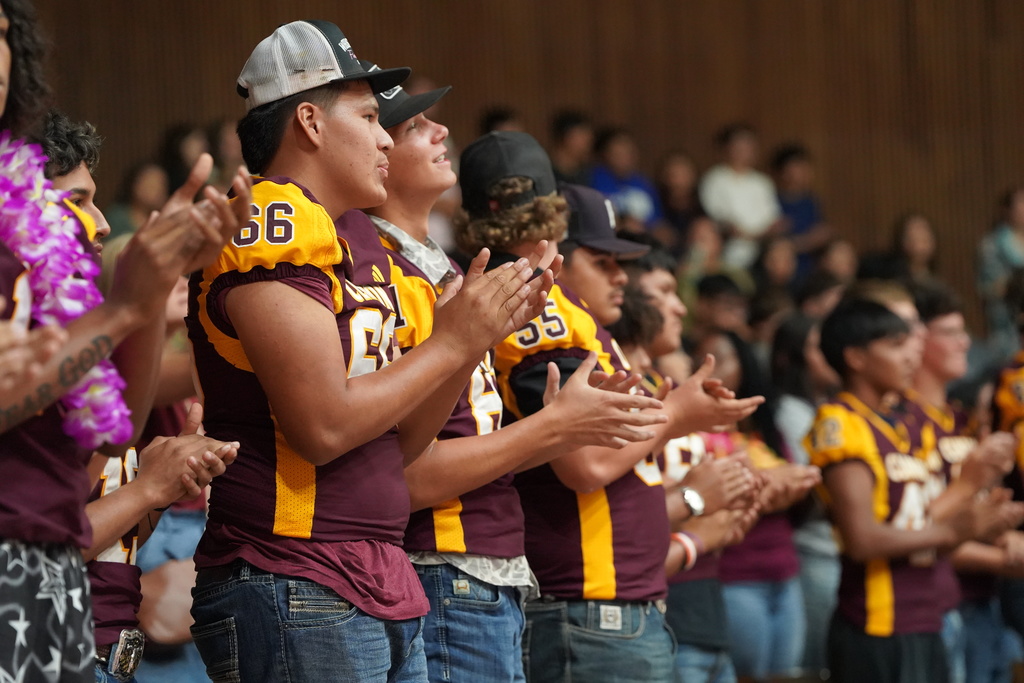 Football players at the pep assembly